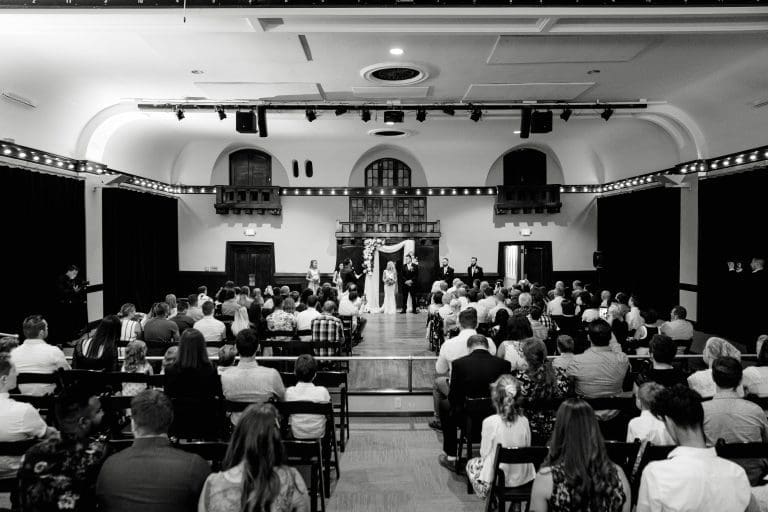 Black and white shot of a bride and groom in Ella's Theater in the Montvale Event Center